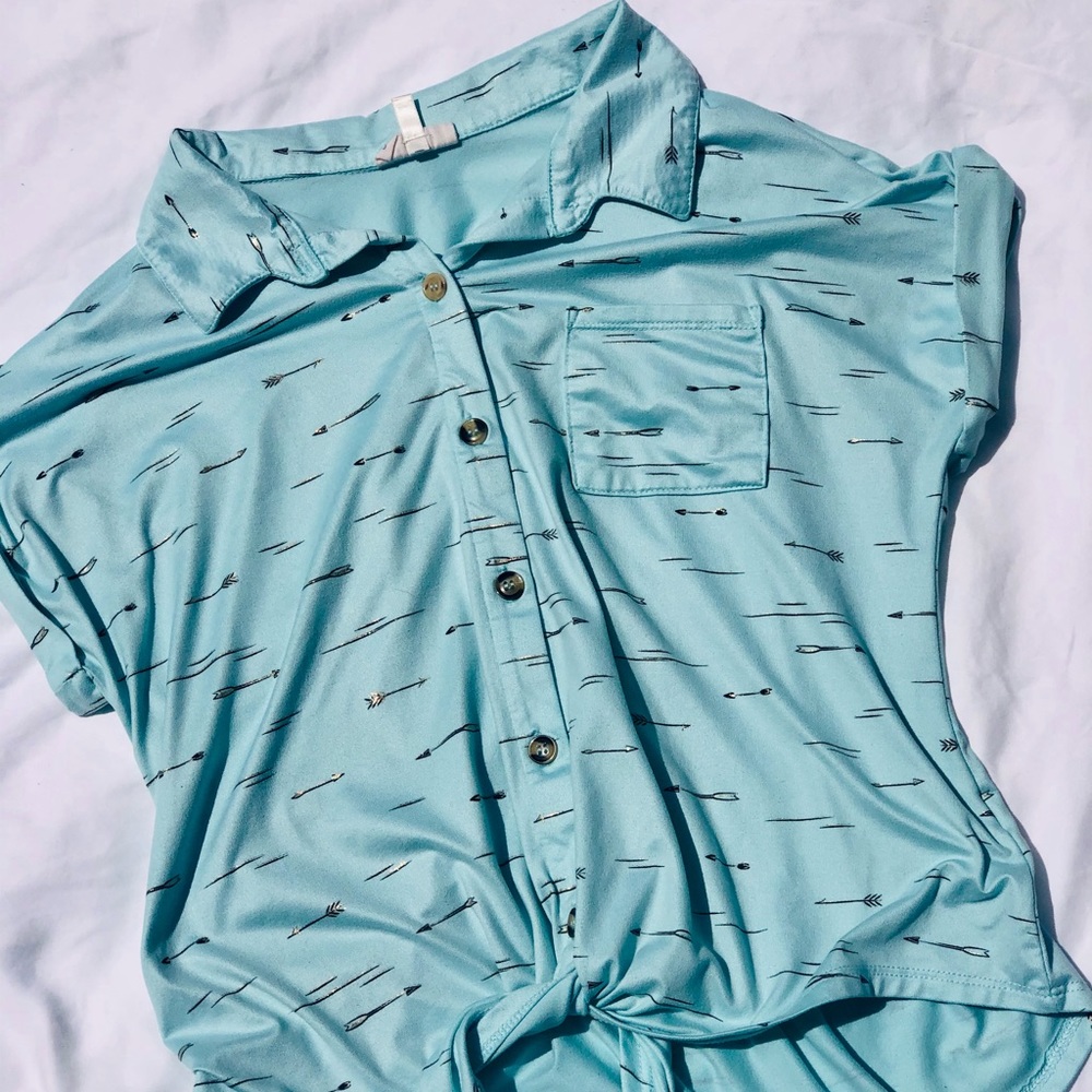 A blue shirt with gold arrows, size XL, from the brand “self esteem”